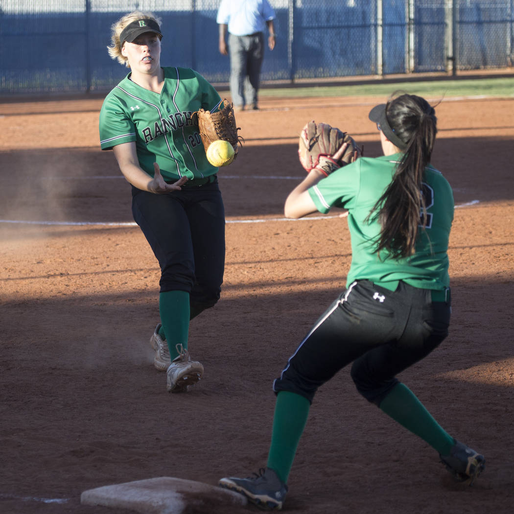 Rancho’s MacKenzie Perry (20) tosses the ball to Jazmin Gonzalez (2) for an out at fir ...