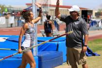 Gabby Carson, of Liberty High School, high-fives Robert Tilley, a coach at Pure Sky Vaulting ...