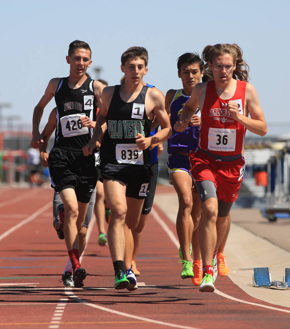 Runners compete in the 1600 meter Sunset Region final during the Sunset and Sunrise Region t ...