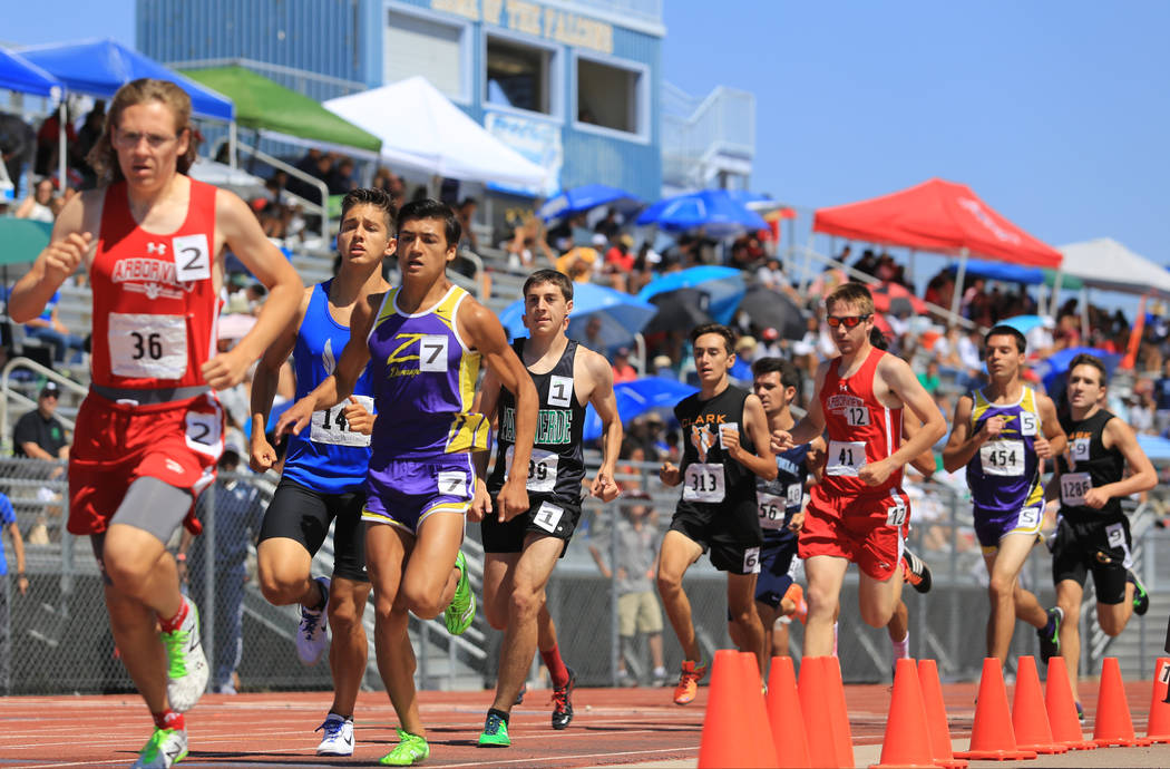 Runners compete in the 1600 meter Sunset Region final during the Sunset and Sunrise Region t ...