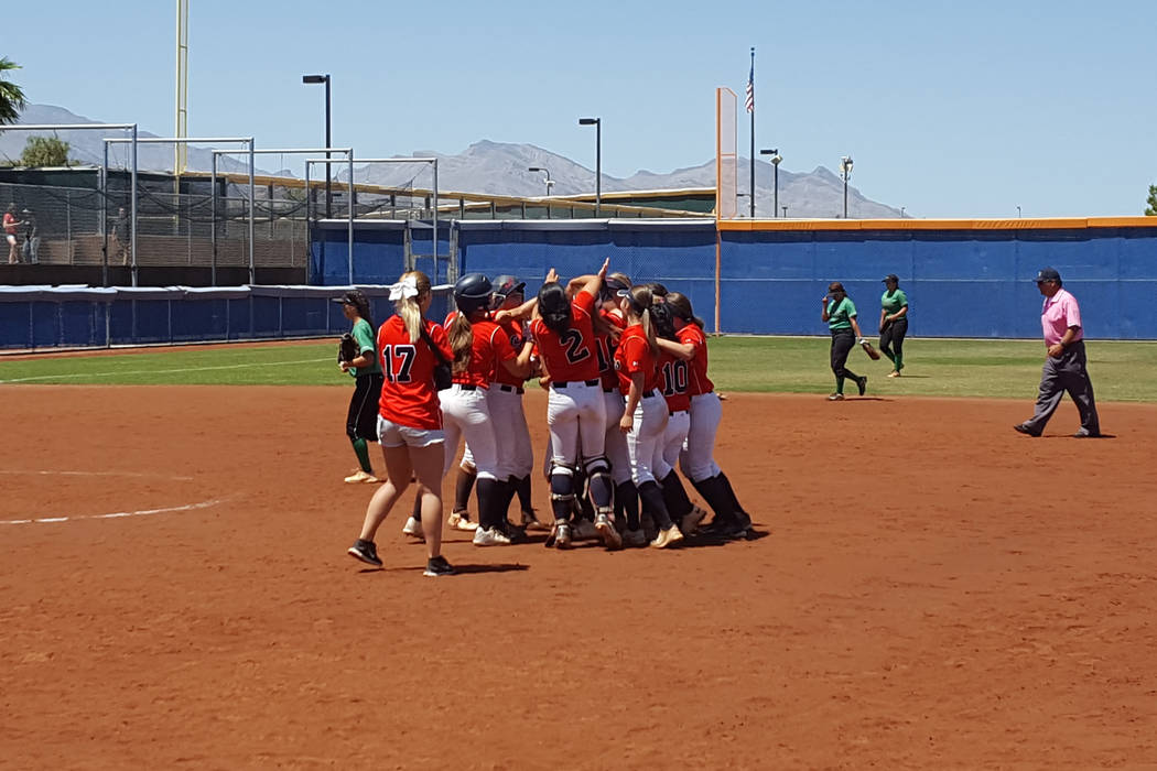 Coronado’s softball team mobs Tatum Spangler after her winning hit in the bottom of th ...