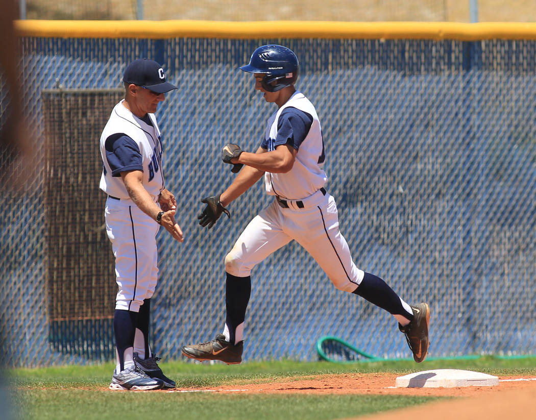 Centennial short stop Jake Rogers (42) gets a high five after hitting a home run during the ...