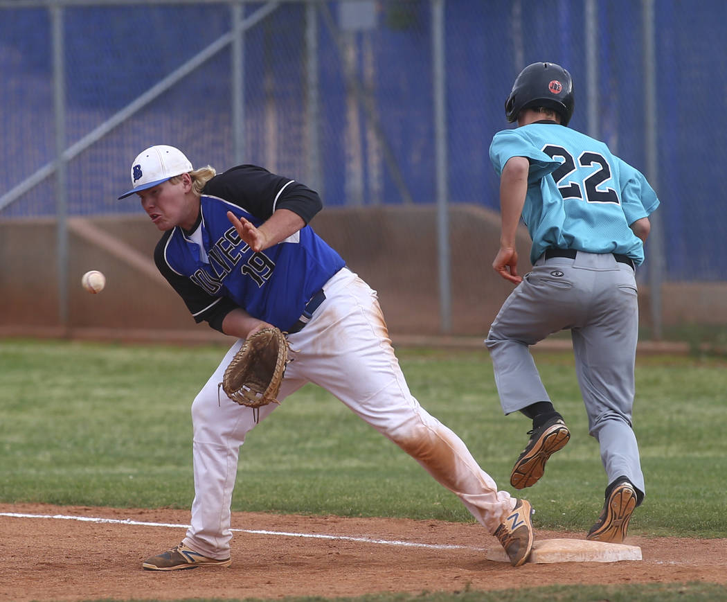 Silverado’s Tyler Paasche (22) makes it to first base against Basic’s Jack Wold ...