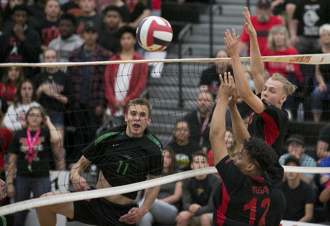 Palo Verde junior Stephen Banks (11) hits the ball over the net as Las Vegas players attempt ...