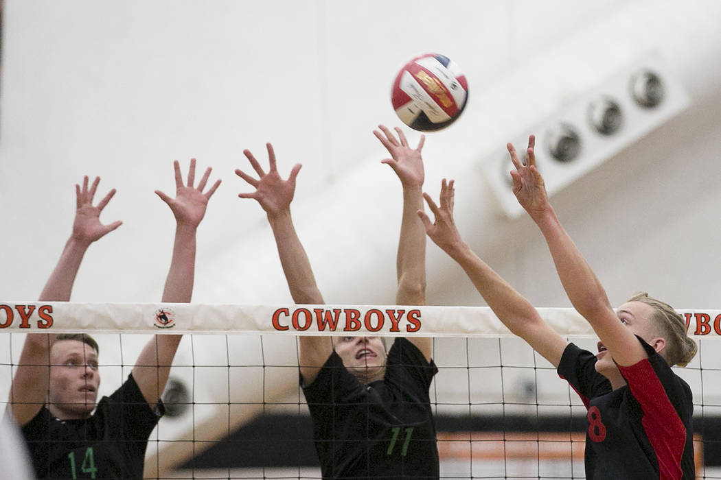 Las Vegas junior Shaun Kampshoff (8), right, attempts to hit the ball over the net as Palo V ...