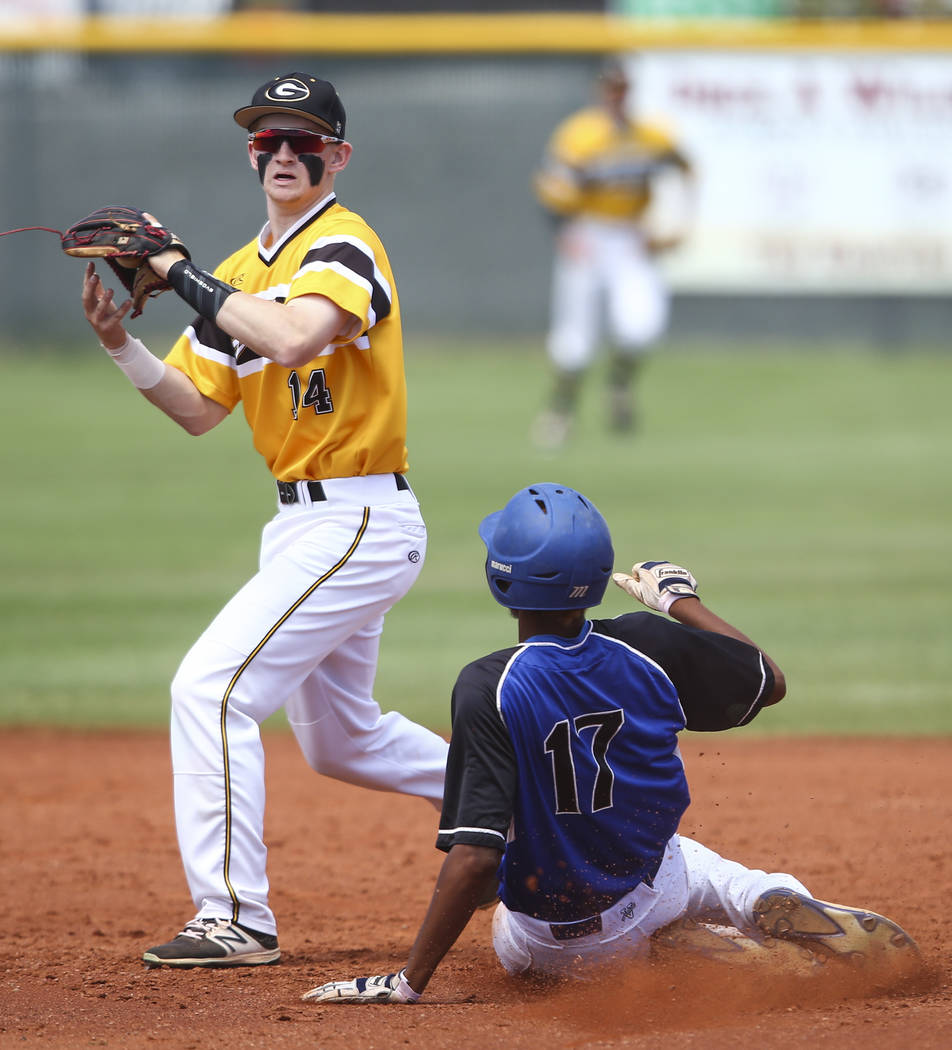 Basic’s Garrett Giles (17) is tagged out by Galena’s Andrew West (14) during a C ...