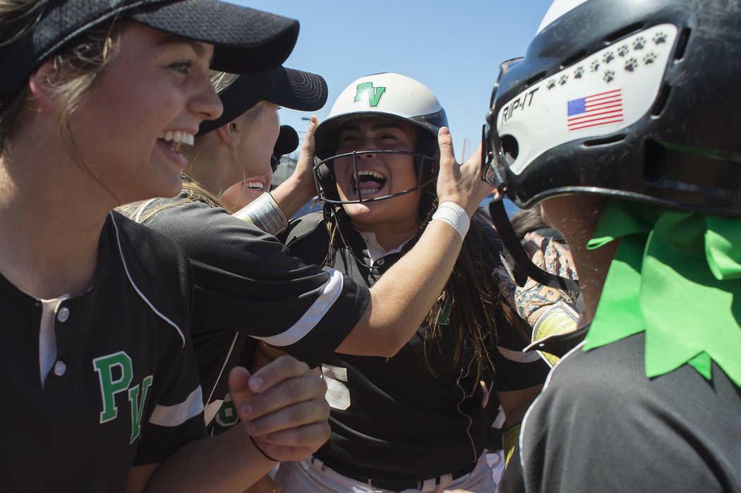 Palo Verde junior Grace Chavez, center, celebrates with her team after she hit a home run du ...