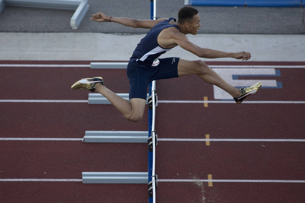 Legacy senior Jamaal Britt takes the lead during the boys 300-meter hurdles at the NIAA Stat ...