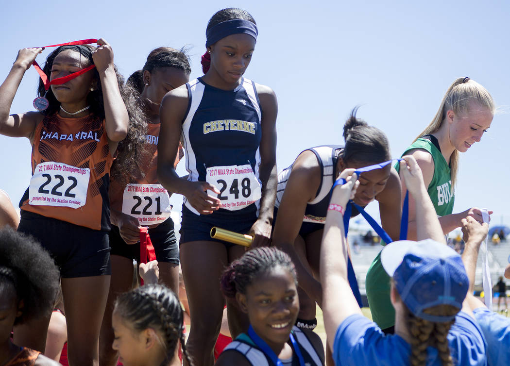Cheyenne runners receive their medals in the girls 400-meter relay during the NIAA 3A State ...