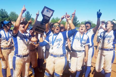 The Needles softball team holds its Class 2A State Championship trophy high, while singing t ...