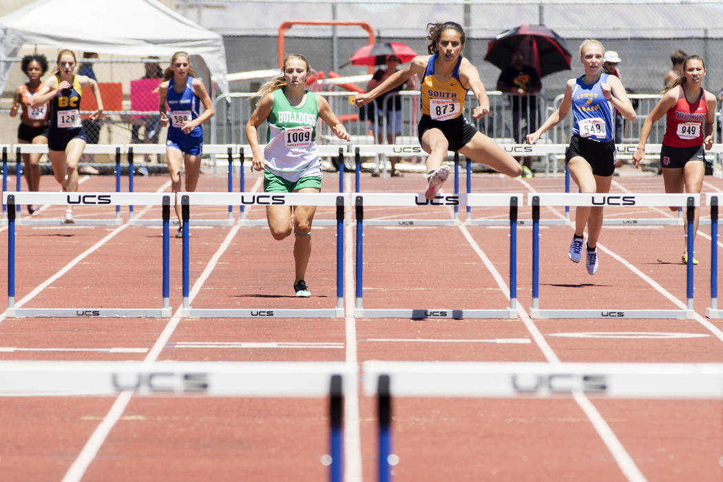 South Tahoe senior Maya Brosch clears a hurdle during the girls 300-meter hurdles during the ...