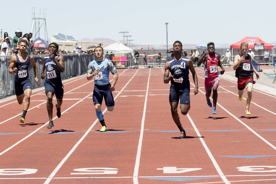Centennial senior Savon Scarver takes the lead in the boys 200-meter dash during the NIAA St ...