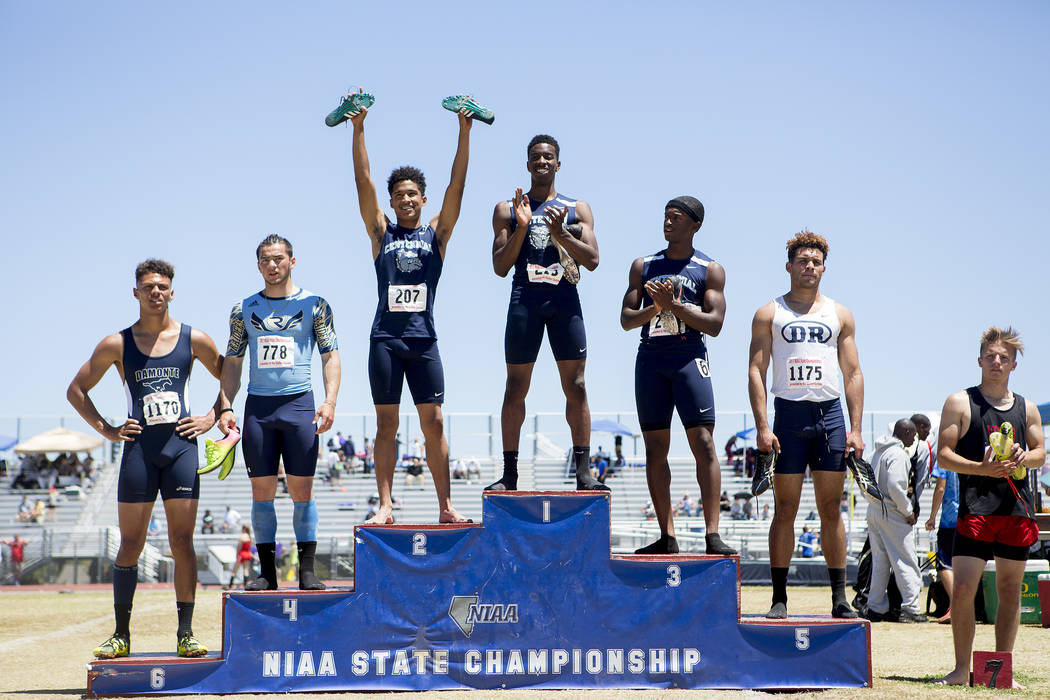 Centennial runners Tre Harley, who placed second, Savon Scarver, who placed first, and Randa ...