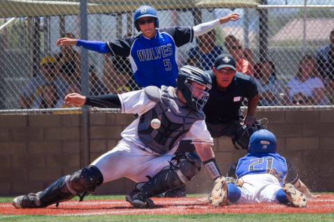 Basic’s Paul Myro, right, slides safely into home plate with the final run of a 16-6 w ...