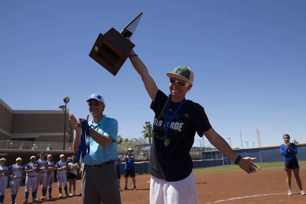 Palo Verde head coach Kelly Glass raises the championship trophy after her team’s 9-3 ...
