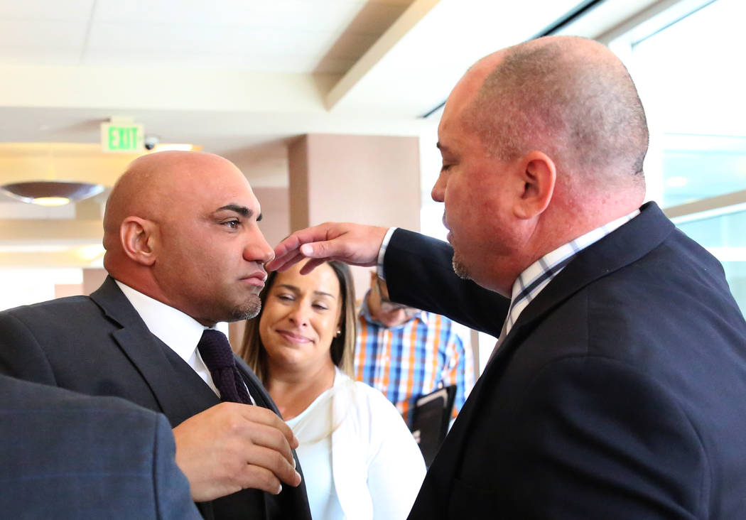 Kenny Sanchez, Bishop Gorman’s head football coach, left, prepares to hug his brother ...
