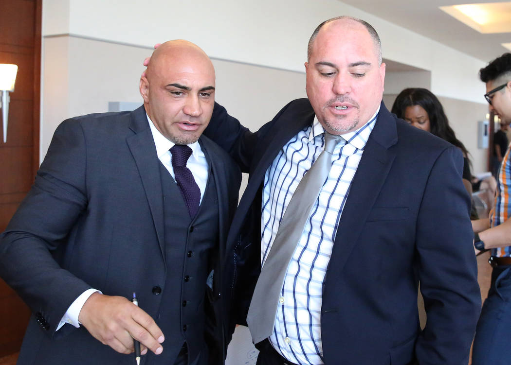 Kenny Sanchez, Bishop Gorman High School football head coach, left, leaves the courtroom wit ...