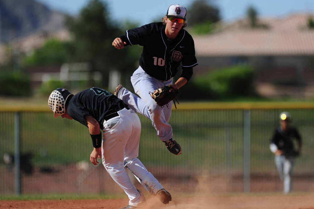 Palo Verde base runner Dylan Orlando (4) interferes with Desert Oasis shortstop Bryson Stott ...