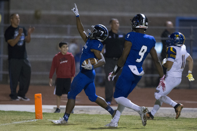 Desert Pines running back Isaiah Morris (7) gestures as he scores a touchdown against Moapa ...