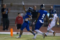 Desert Pines running back Isaiah Morris (7) gestures as he scores a touchdown against Moapa ...