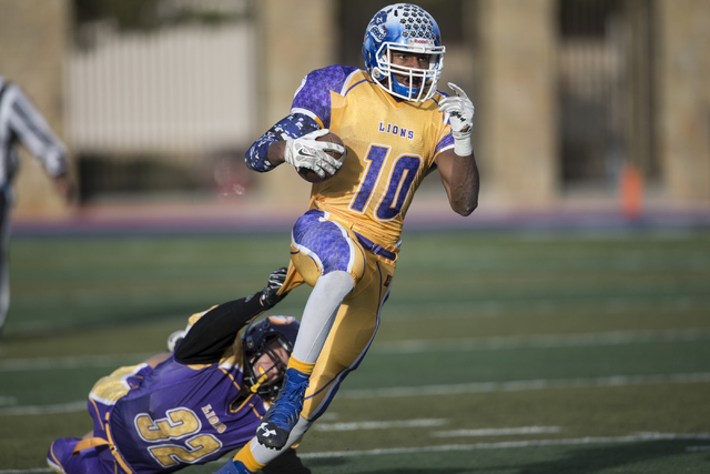 Sunrise All-Stars Frank Harris (10) of Basic avoids a tackle in his run against Sunset All-S ...