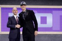 Zach Collins poses for photos with NBA Commissioner Adam silver after being selected by the ...