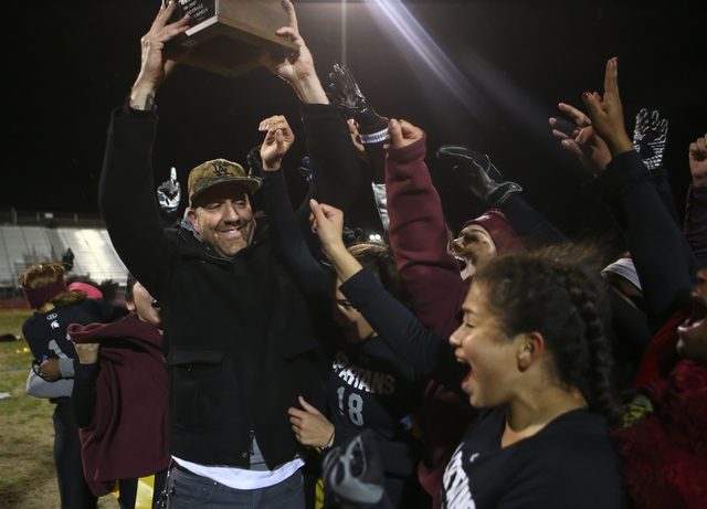 Cimarron-Memorial head coach Mark Bailey celebrates with his players after defeating Coronad ...