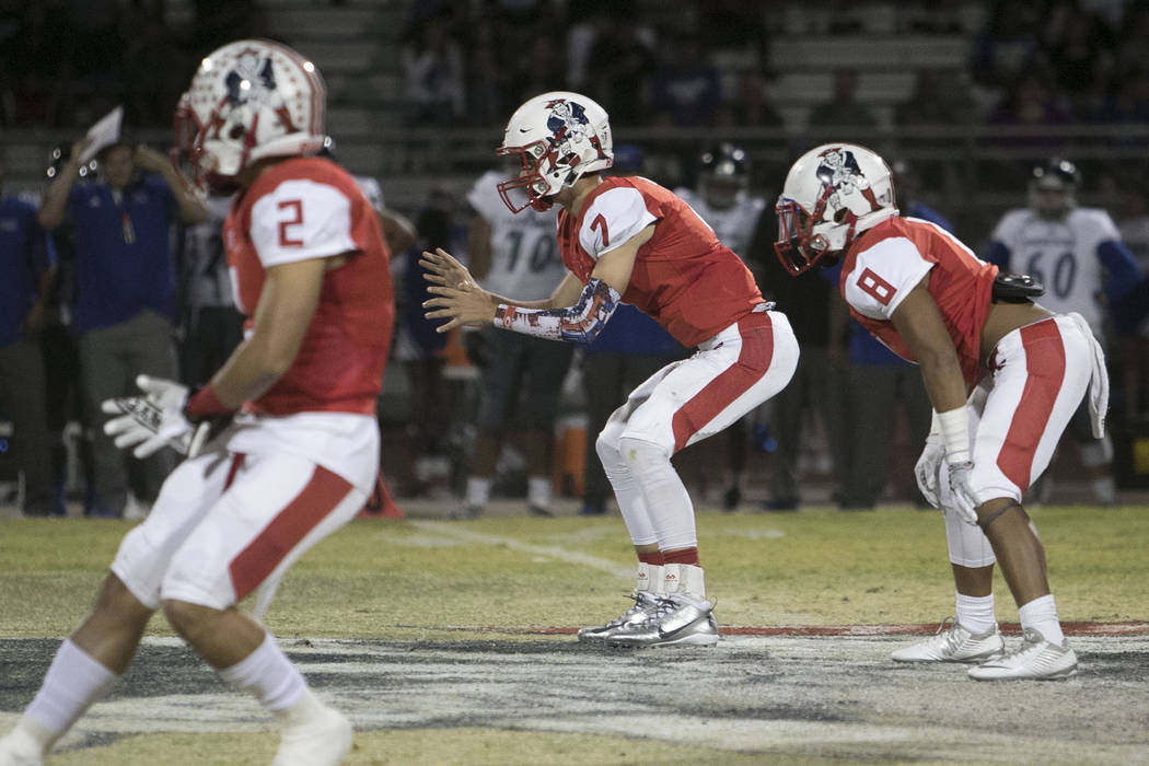 Liberty’s quarterback Kenyon Oblad (7) hikes the ball against Desert Pines during a v ...