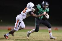 Virgin Valley running back Maurice Jayden Perkins (33) tries to shed a tackler during the Vi ...