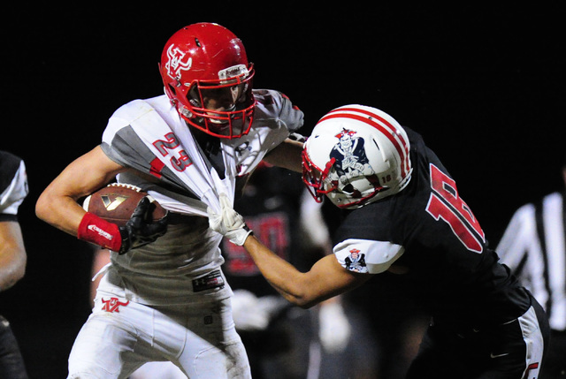 Liberty defensive back Damahny Whittle, right, tackles Arbor View running back Deago Stubbs ...