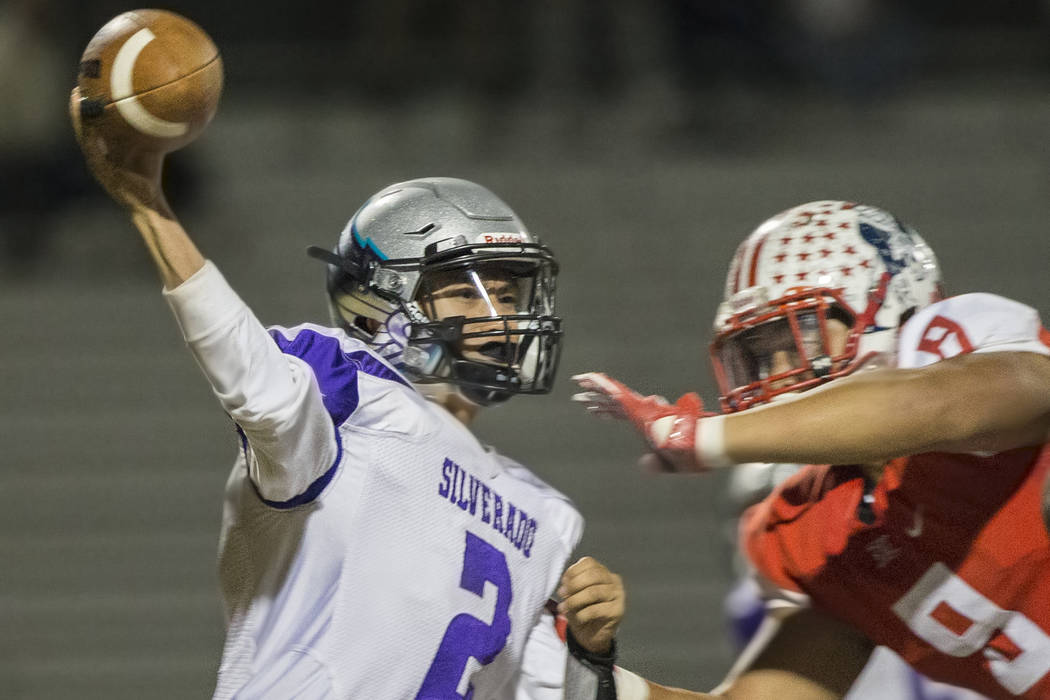 Silverado’s Christian Baltodano (2) just gets a pass away as he’s hit by Liberty ...