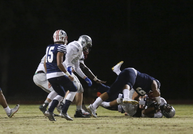 Green Valley running back Julian Hulse (22) is tackled by Liberty’s Crishaun Lappin (9 ...