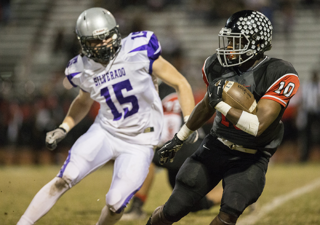 Las Vegas’ Elijah Hicks (10) tries to elude Silverado’s John Thomas Keller (15) ...