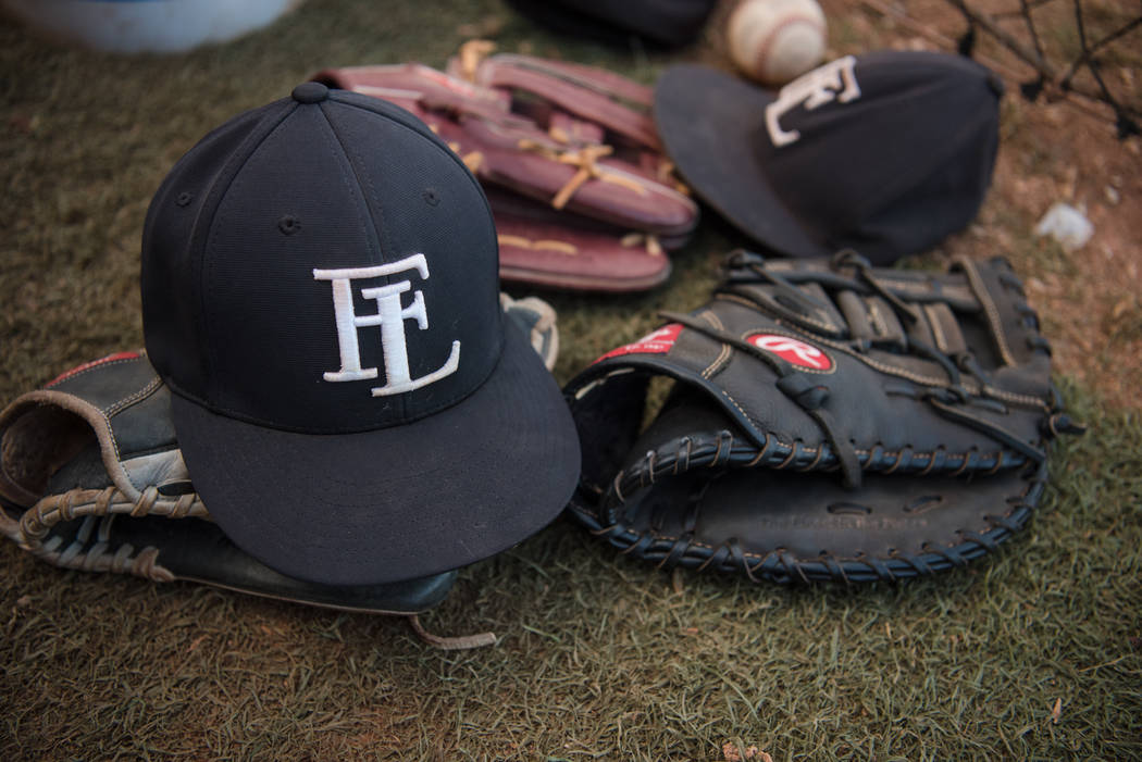 Faith Lutheran hats and baseball mits in the dugout at Faith Lutheran High School on Thursda ...