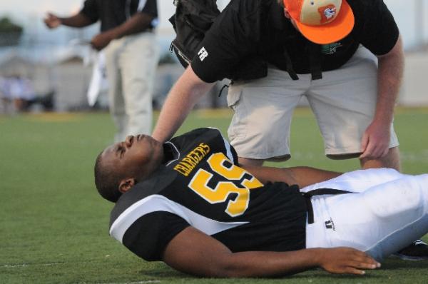 An athletic trainer tends to injured lineman&nbsp;K Rell Craft during Clark’s 39-0 win ...
