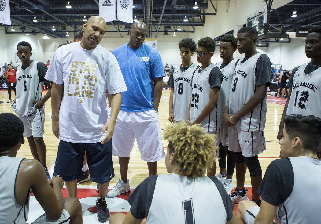 Big Baller Brand AAU team coach LaVar Ball talks with his players during an Adidas Summer Ch ...