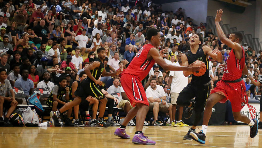 Las Vegas Prospects’ Marvin Coleman II, 2, center, handles the ball against California ...