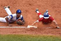 Omaha, Neb., shortstop Zach Luckey slides safely into third in game 2 of The American Legion ...