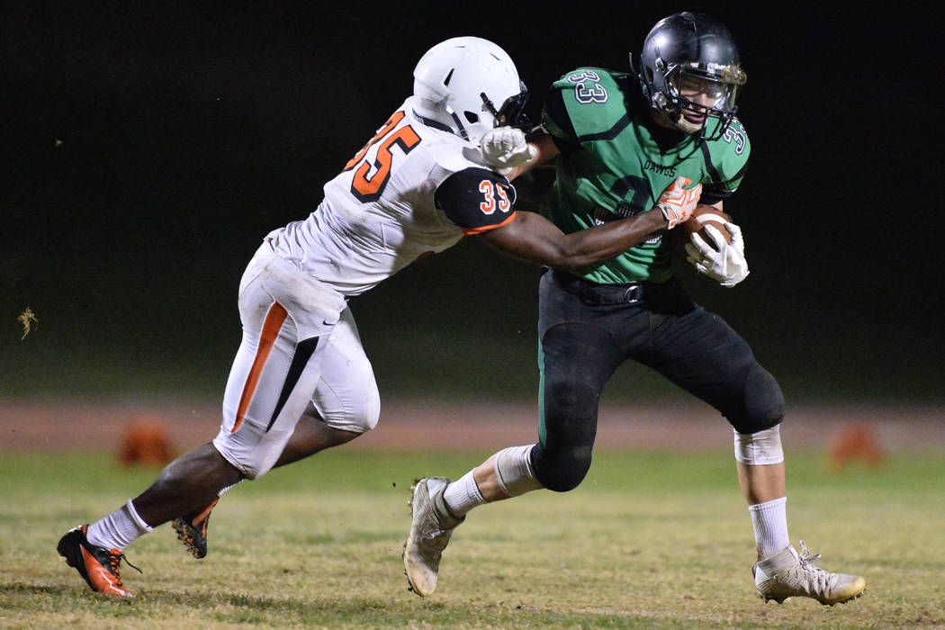 Virgin Valley running back Jayden Perkins (33) tries to shed a tackler during the Virgin Val ...