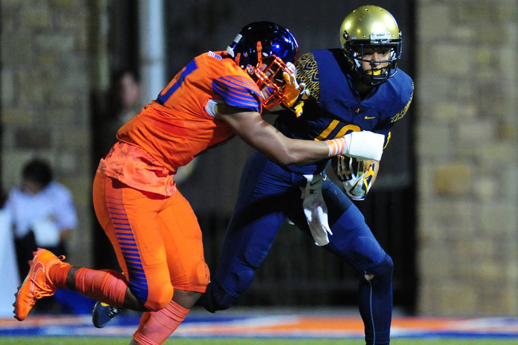 St. Thomas Aguinas, Fla. Trevon Grimes grabs the facemask of Bishop Gorman offensive lineba ...