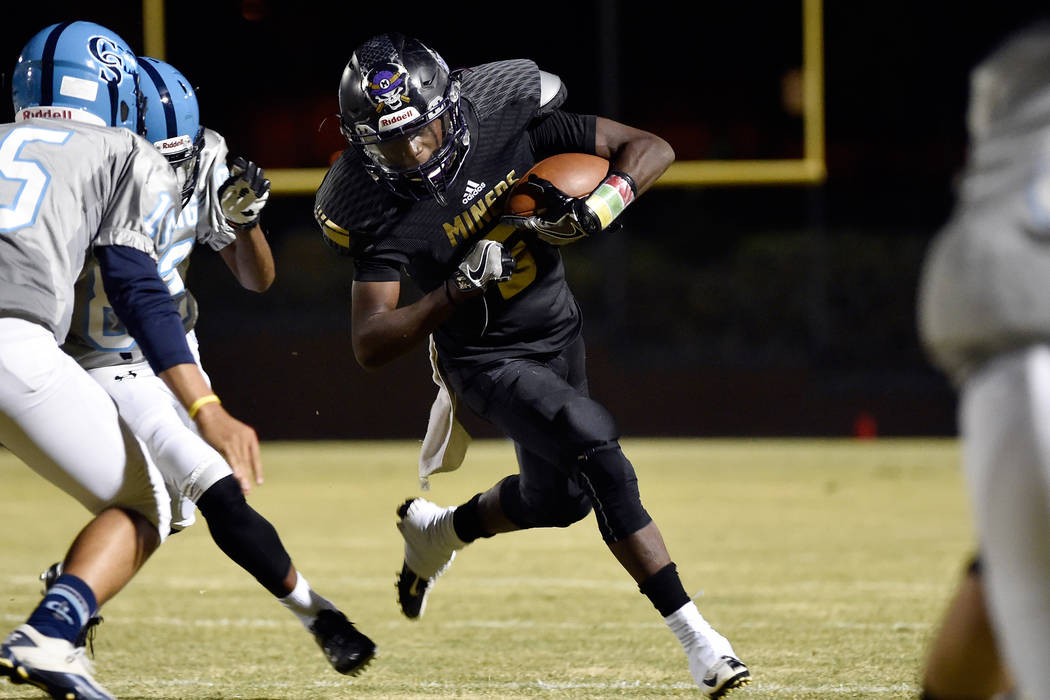 Sunrise Mountain’s Xavier Kyles runs with he ball against Canyon Springs during a high ...