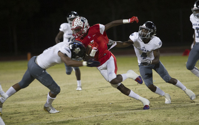 Liberty wide receiver Marquez Powell (1) carries the ball against Desert Pines players durin ...