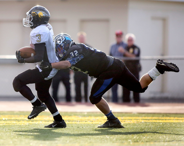 Spring Mountain’s Tyriq McKinney (3), completes a touchdown during the class 1A state ...