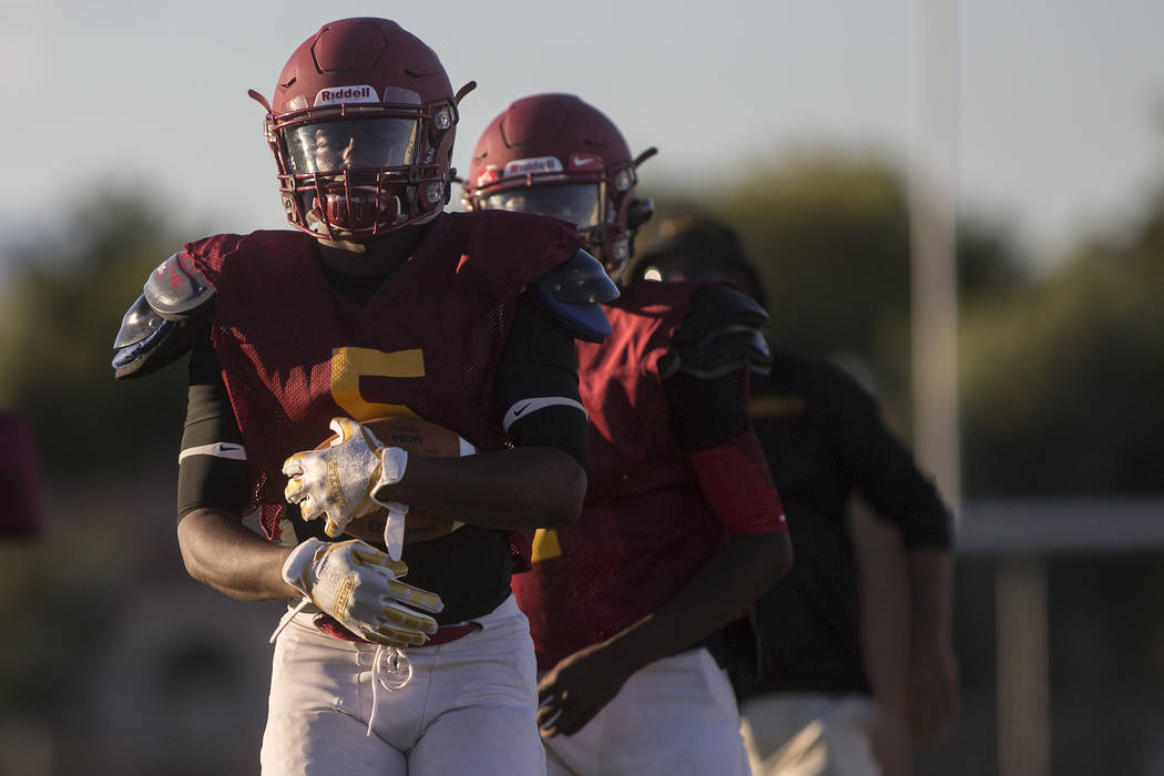 Del Sol senior Taariq Flowers holds the ball while he warms up before a three-team scrimmage ...