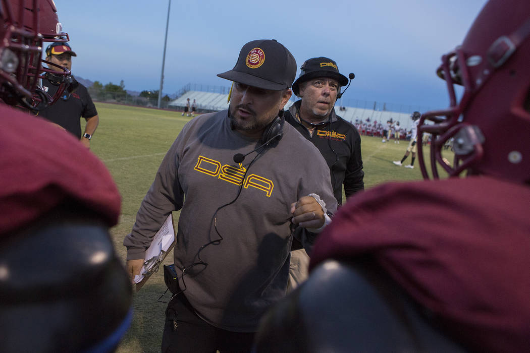 Del Sol head coach Mike Valenzuela speaks with players during a three-team scrimmage at Del ...