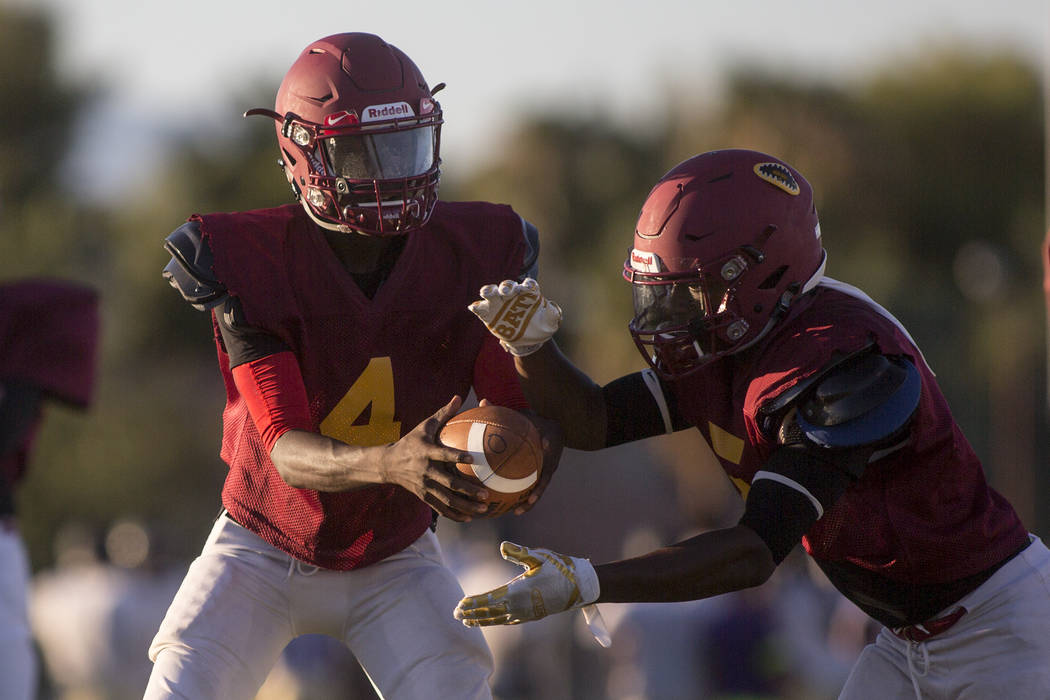 Del Sol sophomore Maalik Flowers, left, hands the ball off to his brother and teammate Taari ...