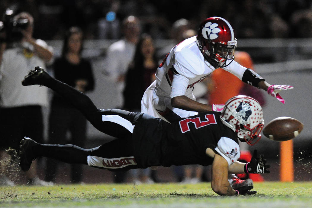 Liberty wide receiver Ethan Dedeaux is unable to catch a low pass as Coronado safety Semaj B ...