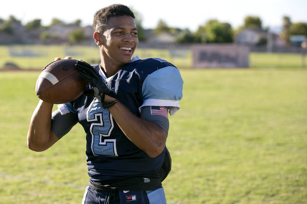 Canyon Springs football player Diamante Burton prepares to pass a ball between drills during ...