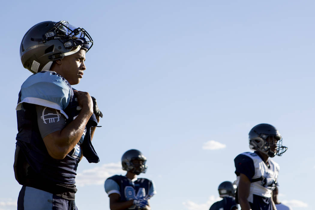 Canyon Springs football player Diamante Burton rests between drills during practice at Canyo ...