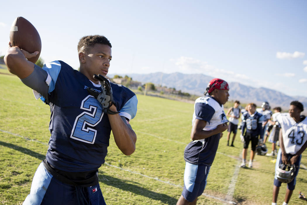 Canyon Springs football player Diamante Burton pass a ball between drills during practice at ...